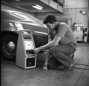 Unidentified male student works on car in Cincinnati State workshop (date unknown)